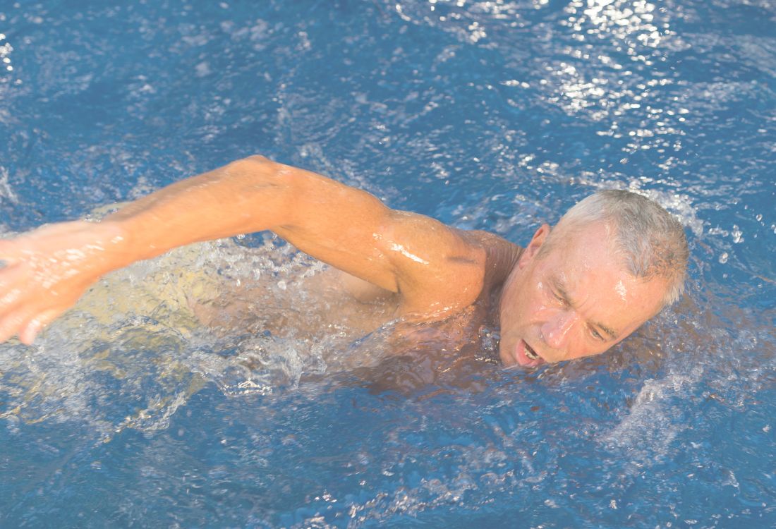 Man swimming in the pool with arthritis